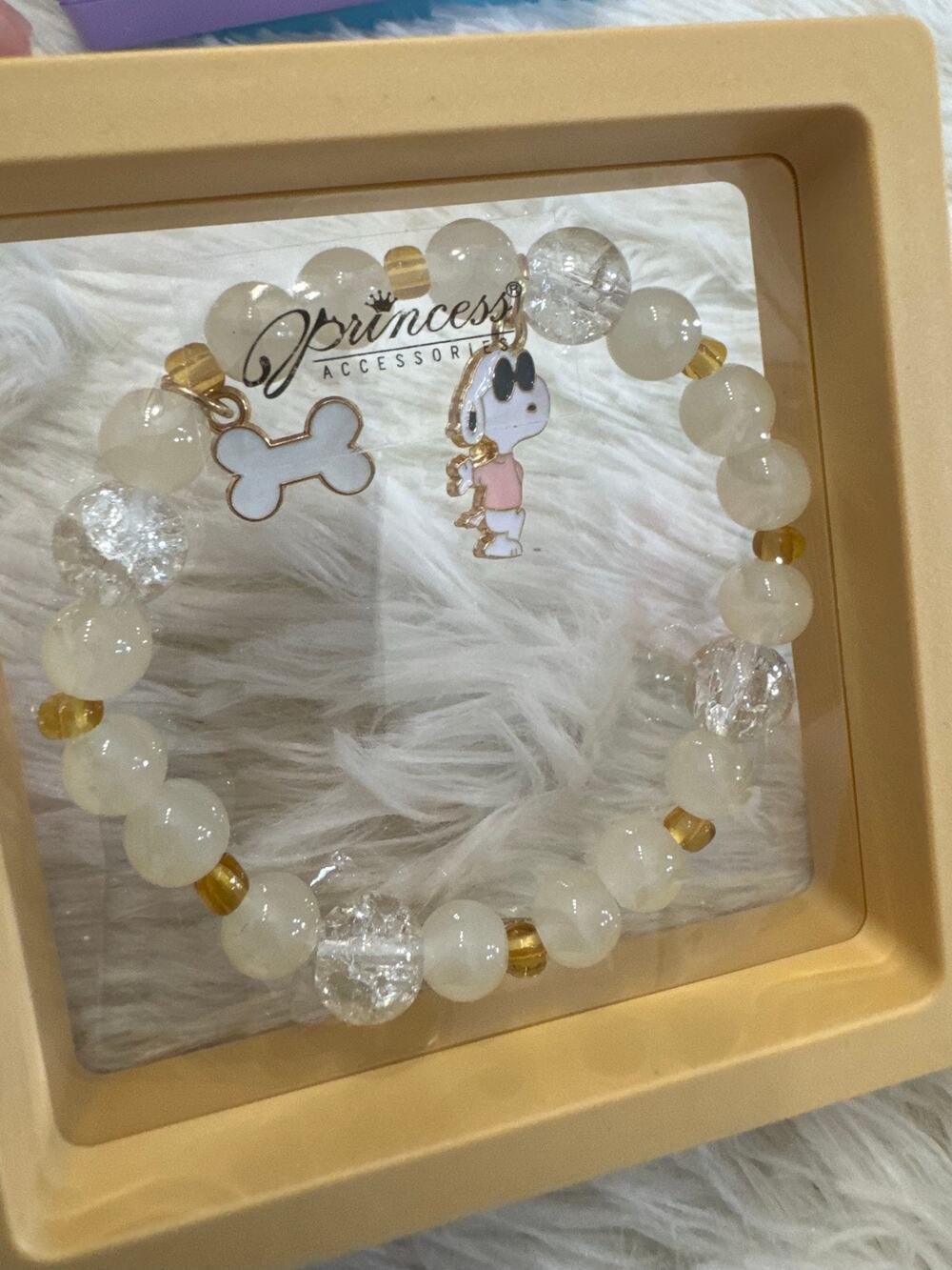 Snoopy beaded bracelet with white and gold beads and Snoopy charm